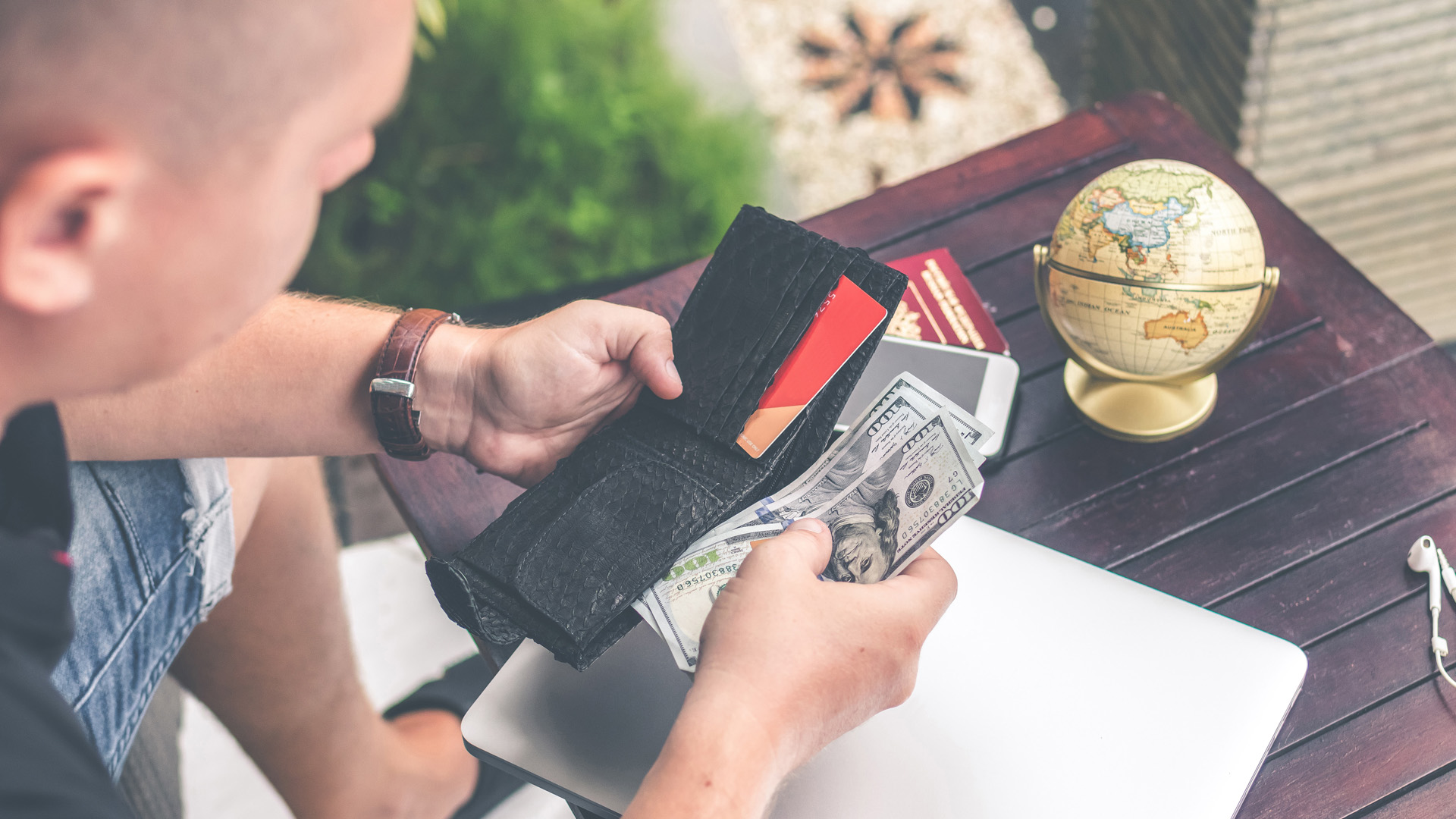 Man Checking Money In Case Of Holiday Fraud