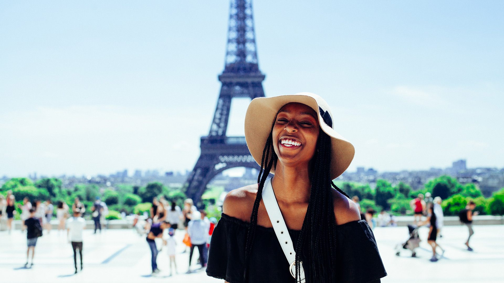 Woman Smiling In Front of Eiffel Tower